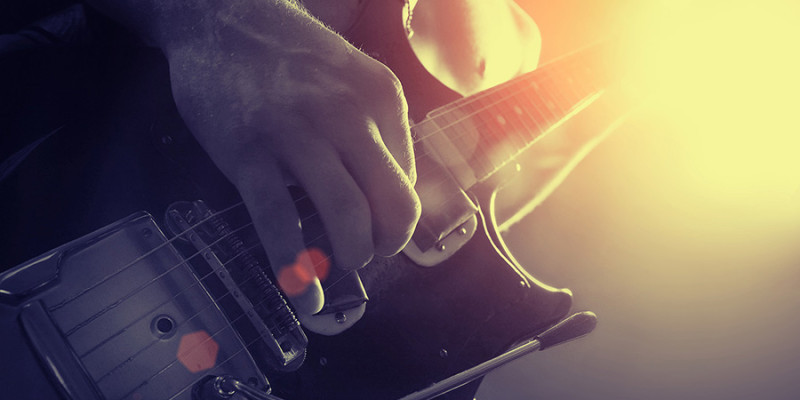 man playing electrical guitar in black and yellow