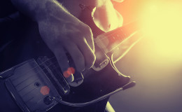 man playing electrical guitar in black and yellow